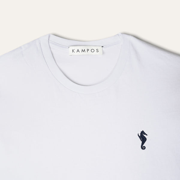 Close-up of the navy seahorse motif on the KAMPOS white T-shirt